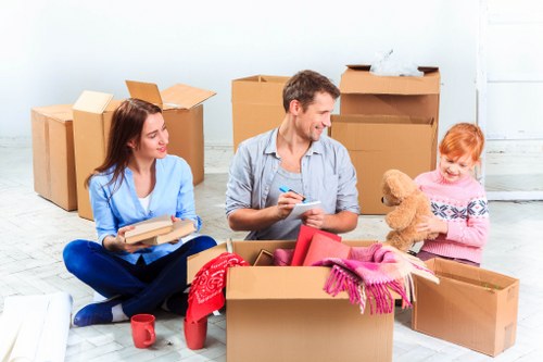 Packed moving boxes and furniture ready for collection in Dagenham