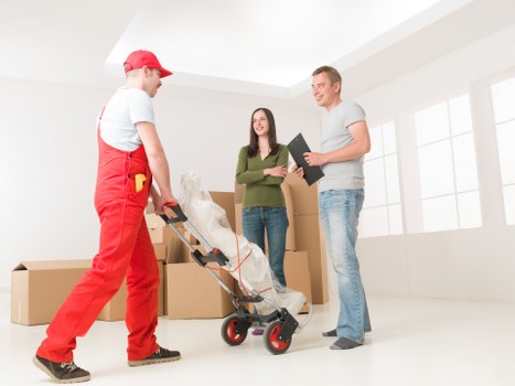 Professional movers handling office equipment during a relocation in Dagenham
